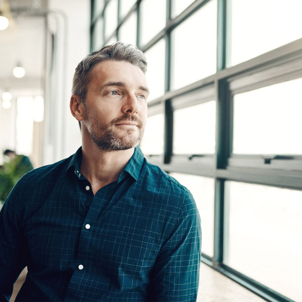 Man looking out of window.