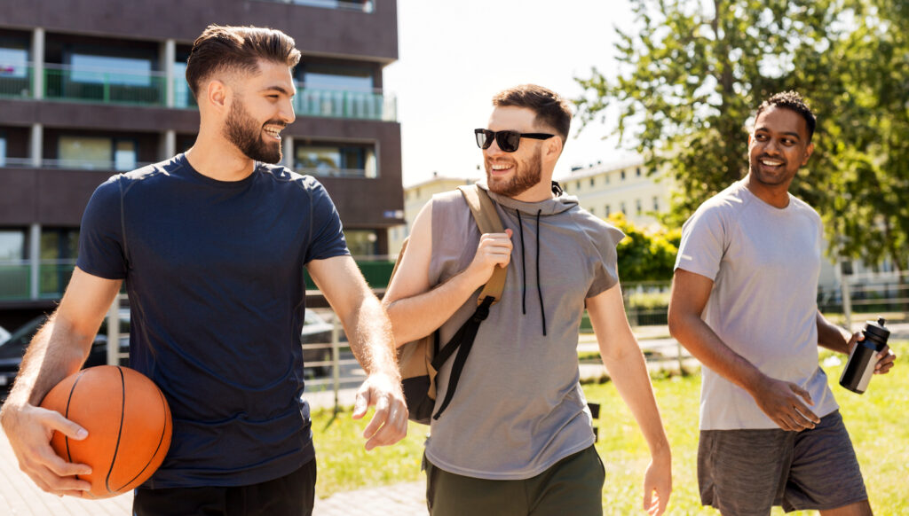 three young men meeting to black basketball