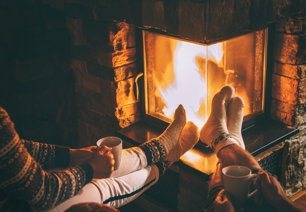 couple by fireplace sharing a sober drink