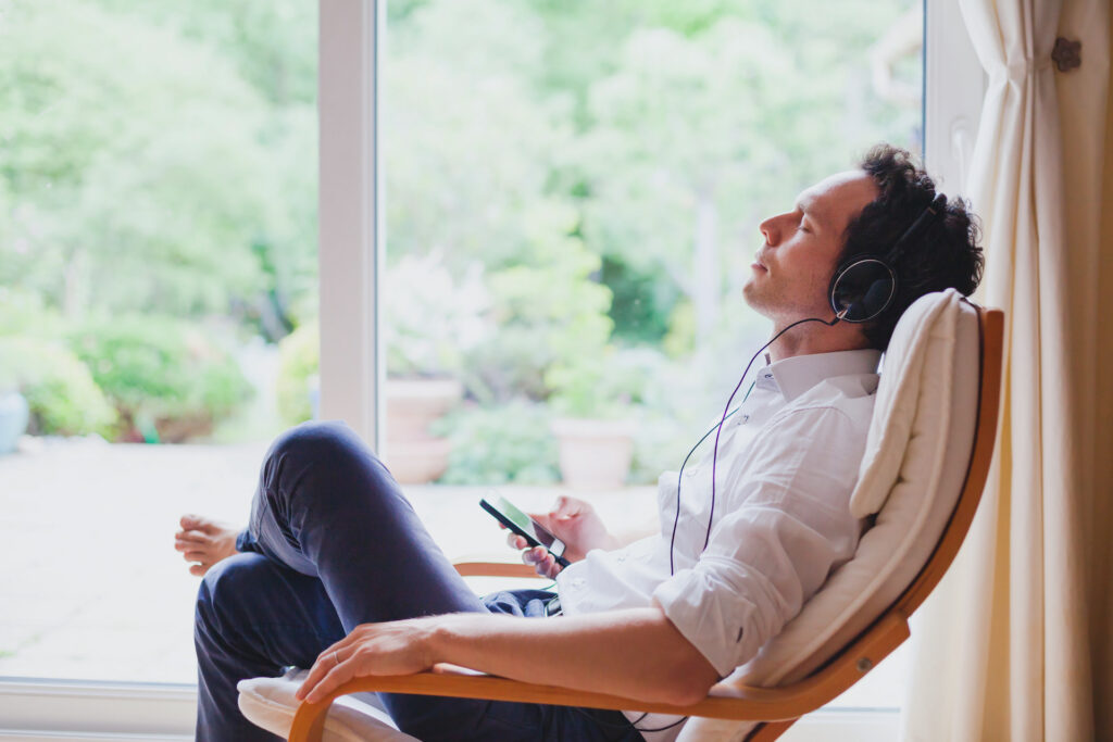 man relaxing listening to meditation audio to combat addiction