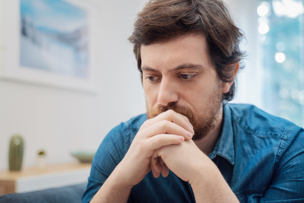 man struggling with feelings of guilt