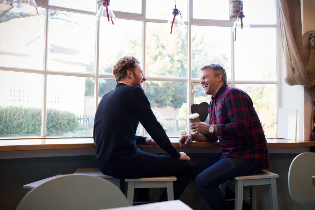 two men sitting in coffee shop unconditional positive regard