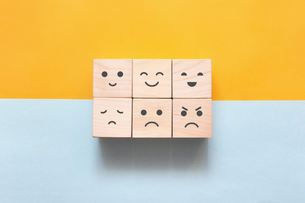 wooden blocks with faces of different emotions