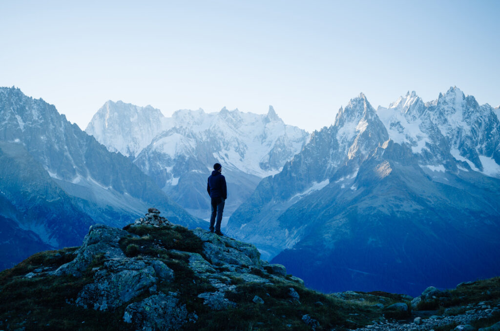 man atop a mountain thinking about life