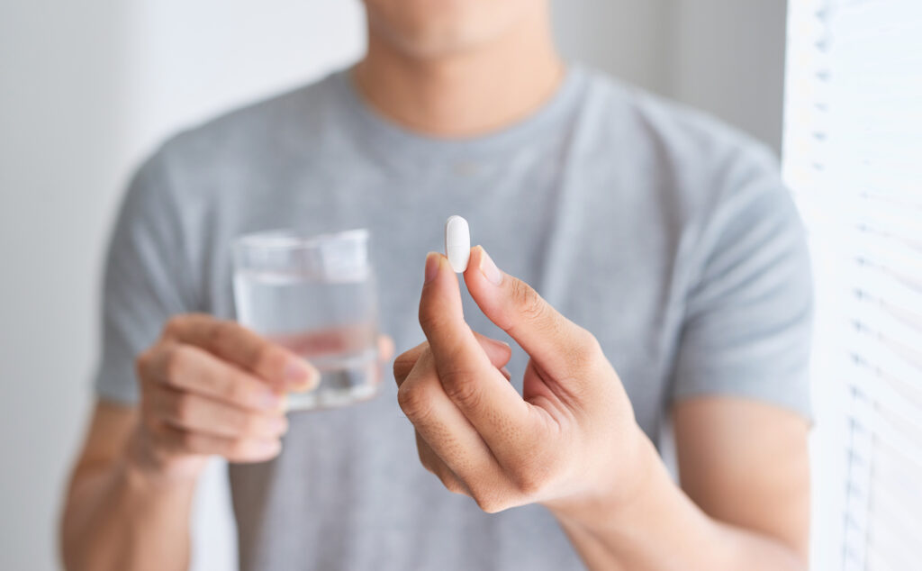 man consuming prescription drugs