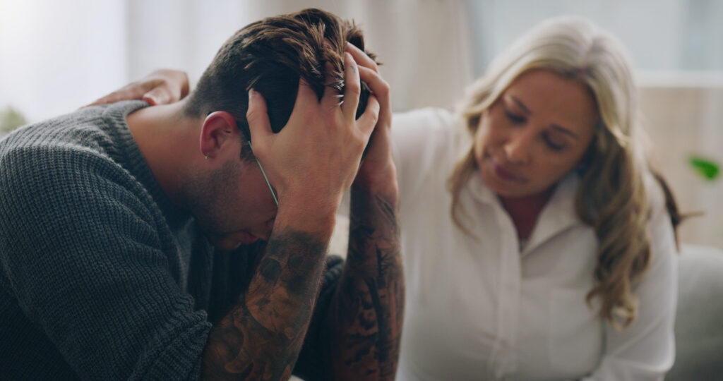 man holding head in hands trying to calm mind