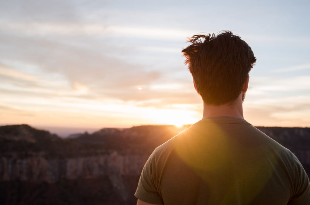 man watching sun set