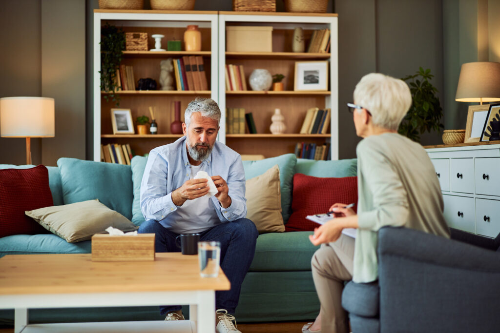 man speaking with therapist about addiction