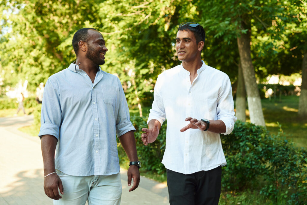 two men talking in a park