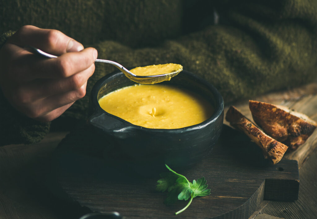 close up of man eating soup