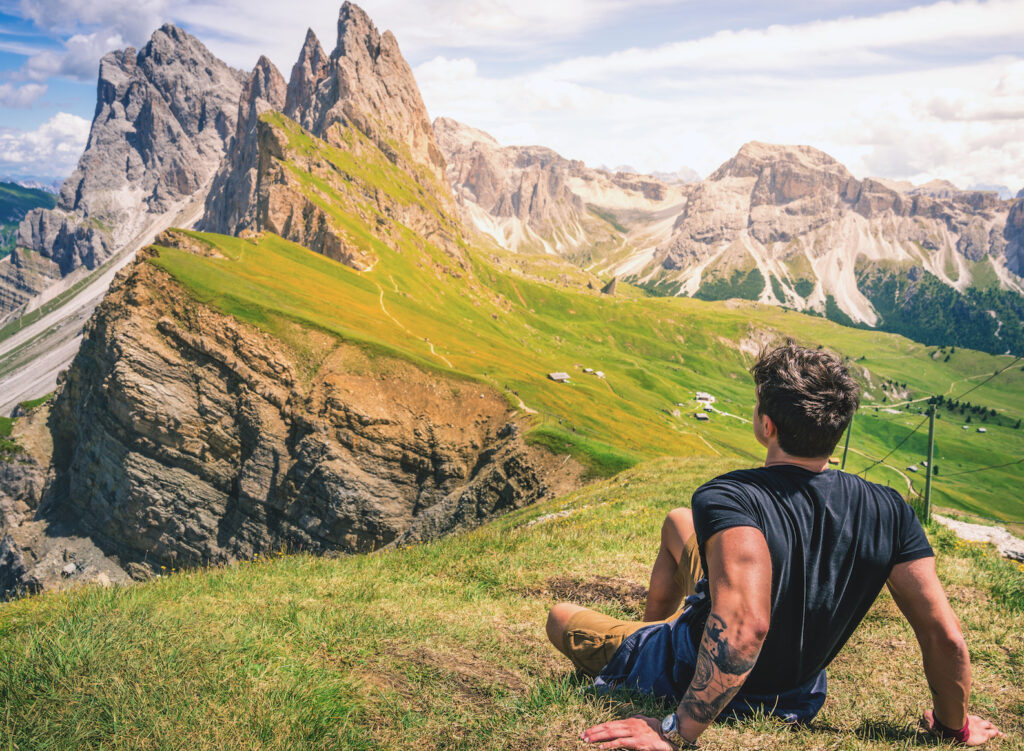 man sitting atop mountain
