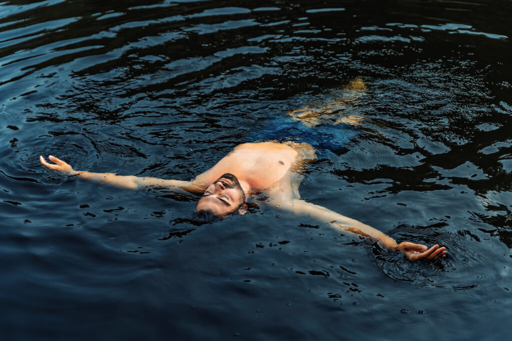 man floating meditatively in water