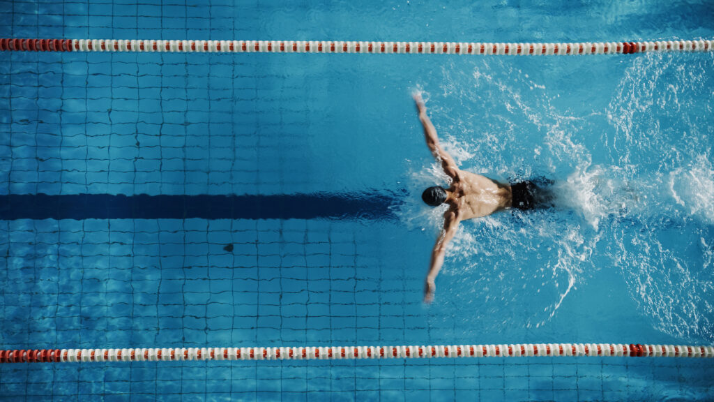 man swimming laps at pool